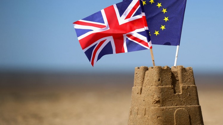 Europe in crisis - Brexit & EU flags in sandcastle